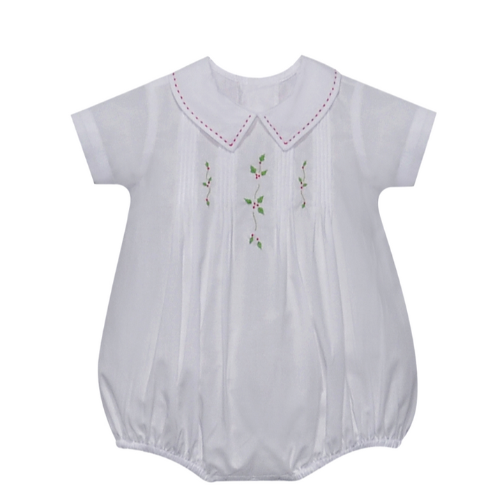 White baby romper with embroidered details on a white background